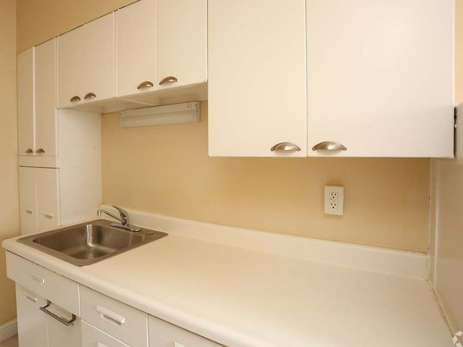 Sink with white cabinets and countertops in an apartment at Edgehill Court in Bala Cynwyd, PA.