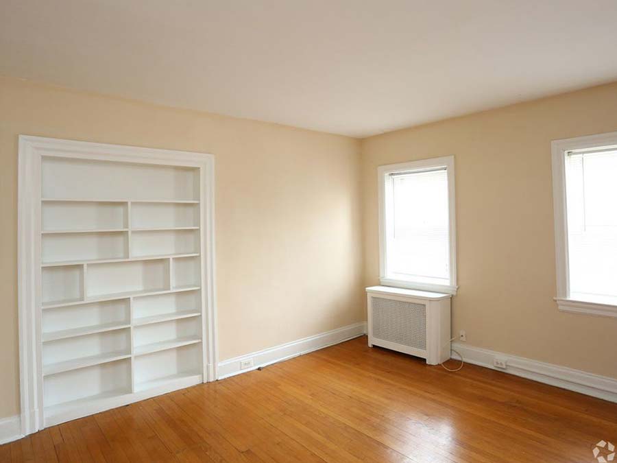 Unfurnished living room space with built-in shelves in an apartment at Edgehill Court in Bala Cynwyd, PA.
