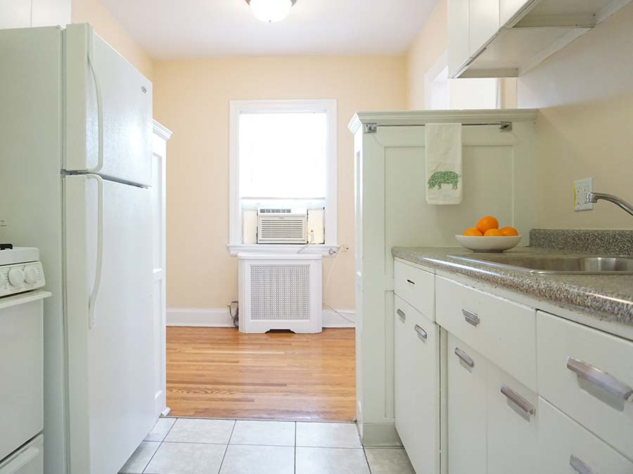 Kitchen area with an AC window unit in the hallway in an apartment at Edgehill Court in Bala Cynwyd, PA.