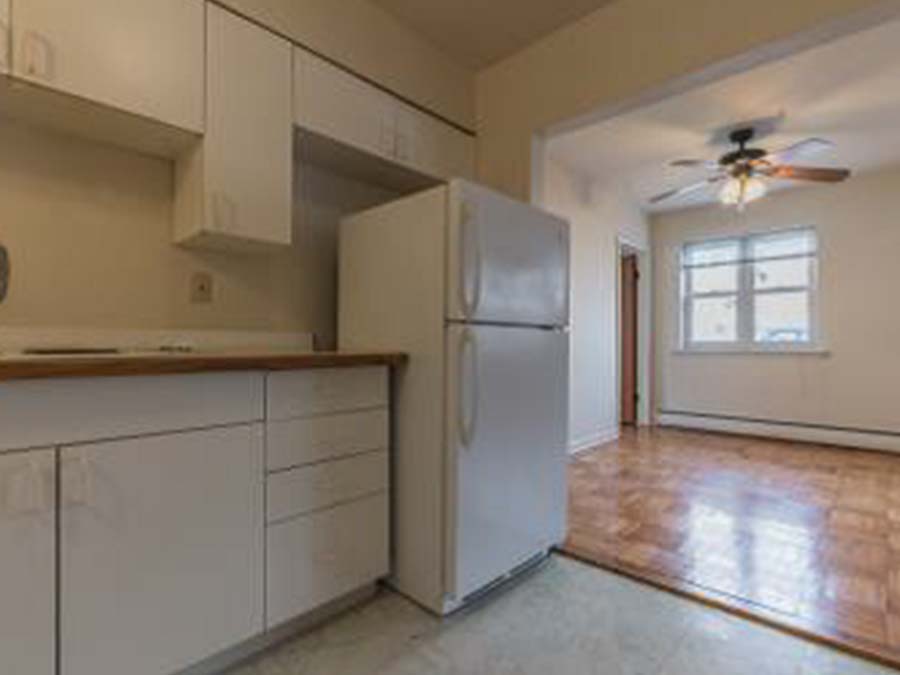Kitchen and living room area with a ceiling fan at Marlyn Apartments in Upper Darby, PA.