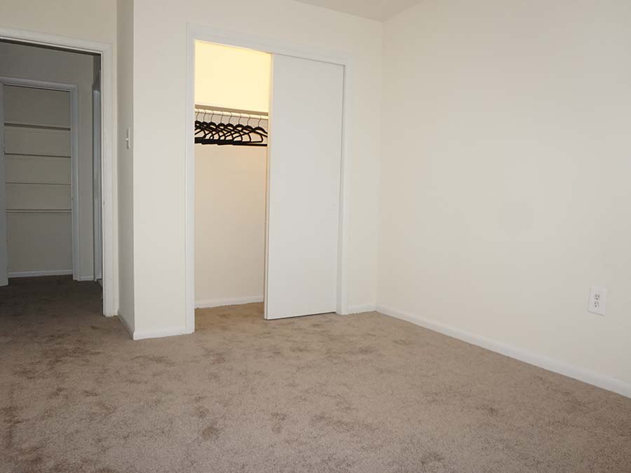 Tan carpeted bedroom with reach-in closet in Patricia Court apartments in Lansdowne, PA.
