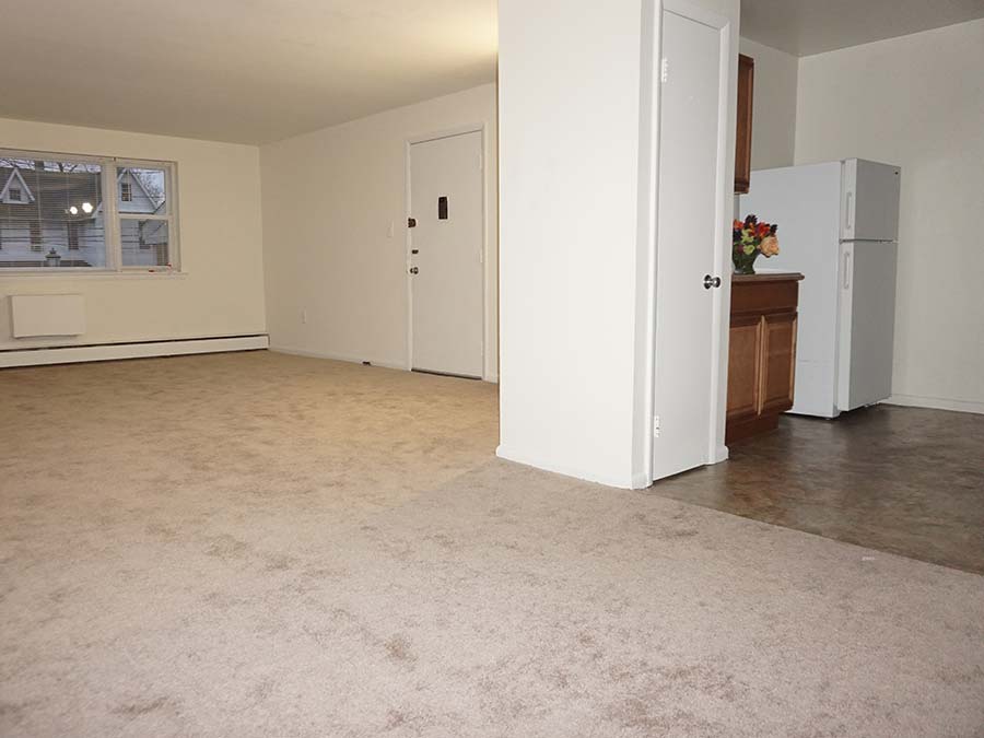 Carpeted living and dining area next to the kitchen in Patricia Court apartments in Lansdowne, PA.