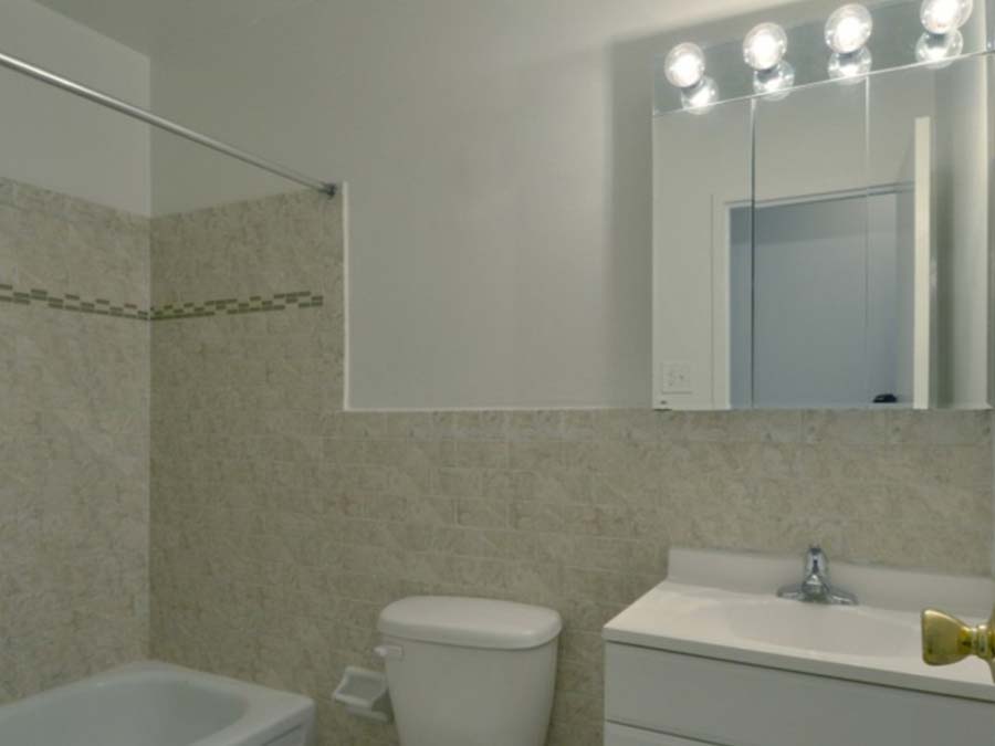 Spacious bathroom with tiled tub and sink at Ridgeway Court in Lansdowne, PA.
