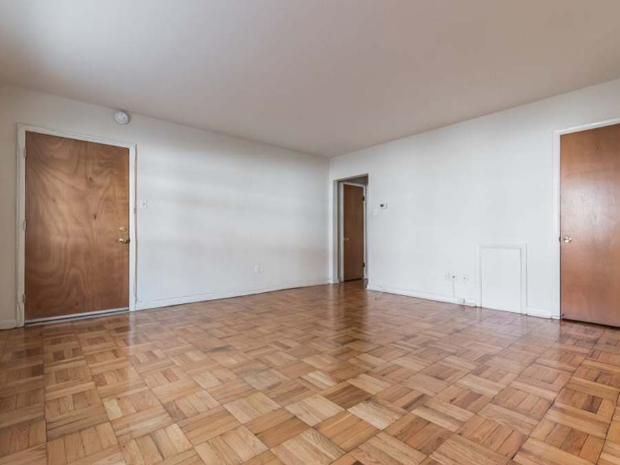 Dark parquet flooring in the living area at Sheldrake Apartments in Upper Darby, PA.