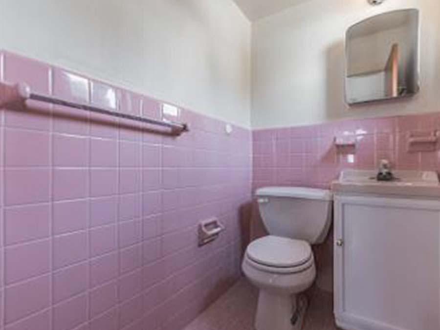 Large tiled bathroom with sink a medicine cabinet at Sheldrake Apartments in Upper Darby, PA.