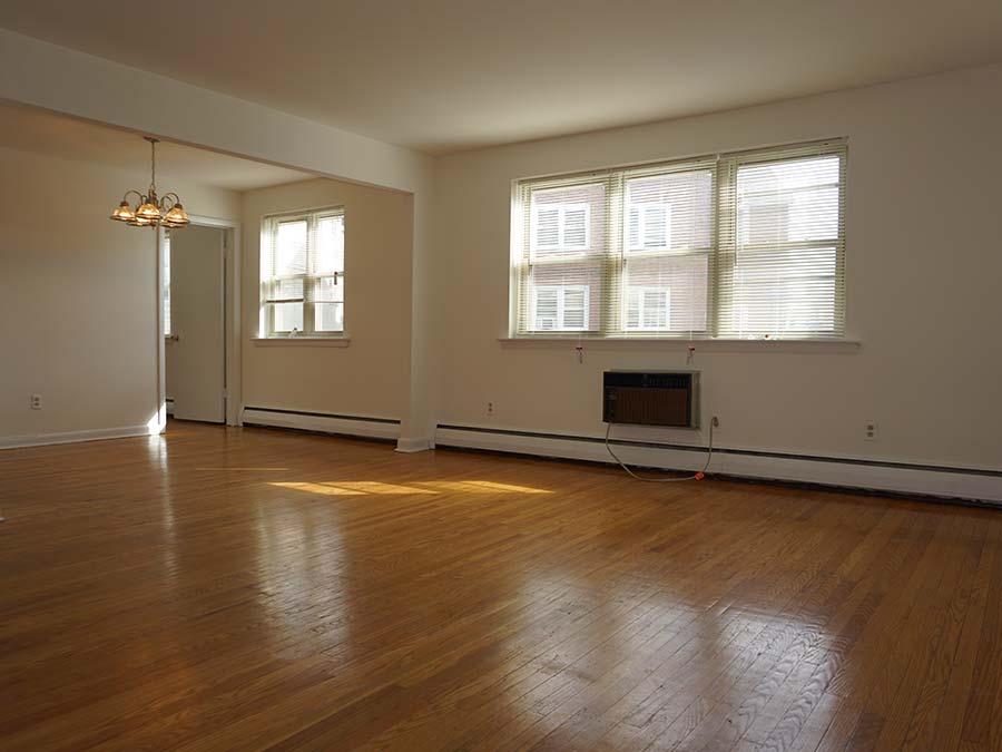 Wood flooring and large windows in the living area at the Sheldrake Apartments in Upper Darby, PA.