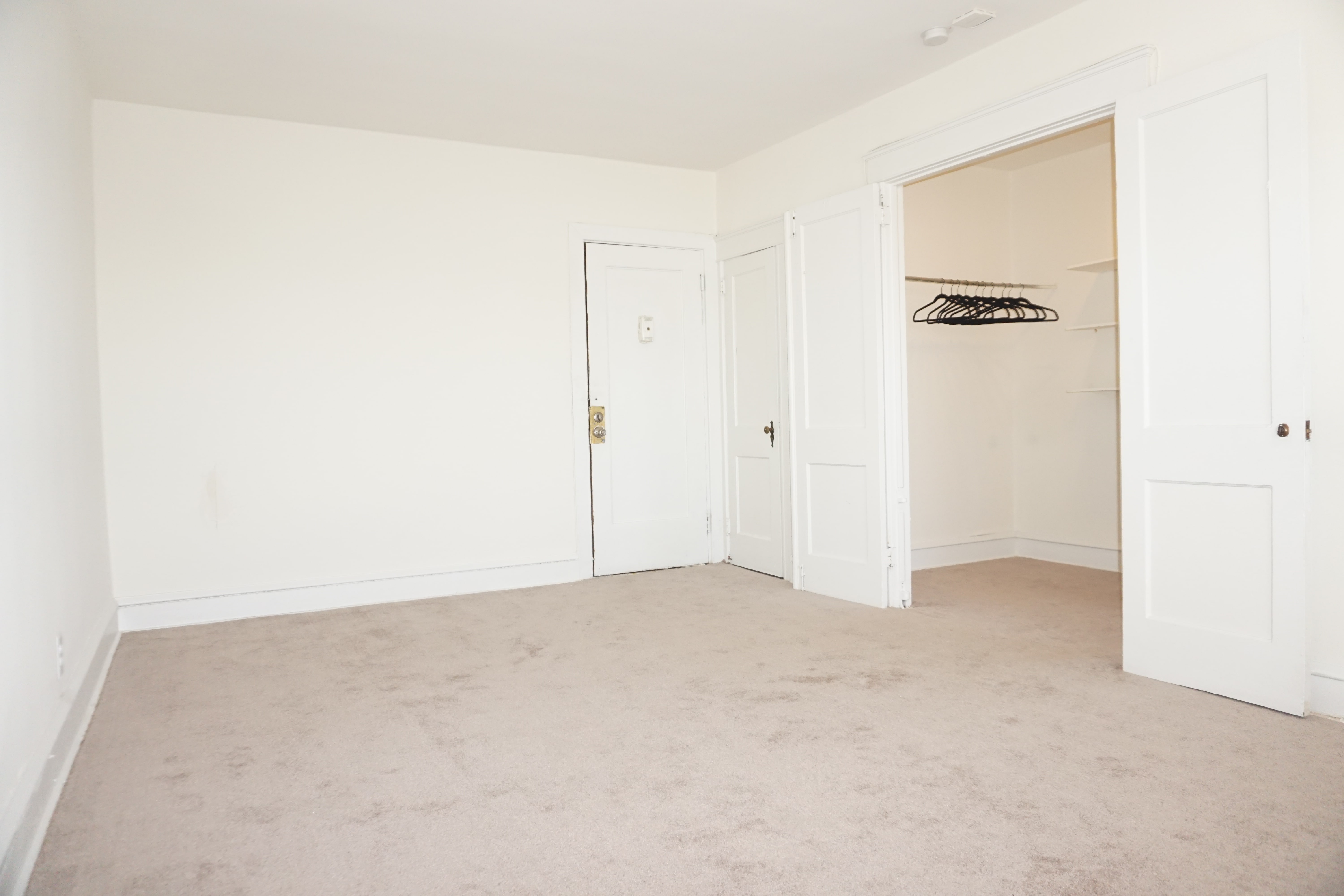 Spacious bedroom with walk-in closet in an apartment at Marshall House in Lansdowne, PA.