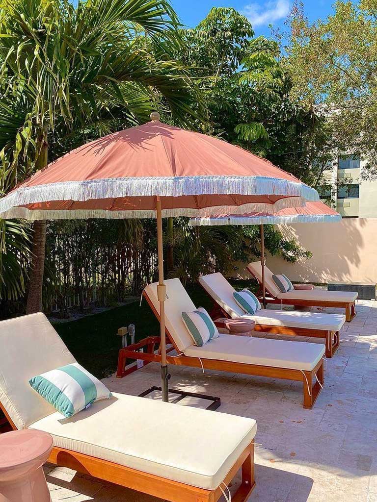 The Villas at Boynton Beach pool lounge chairs and umbrellas
