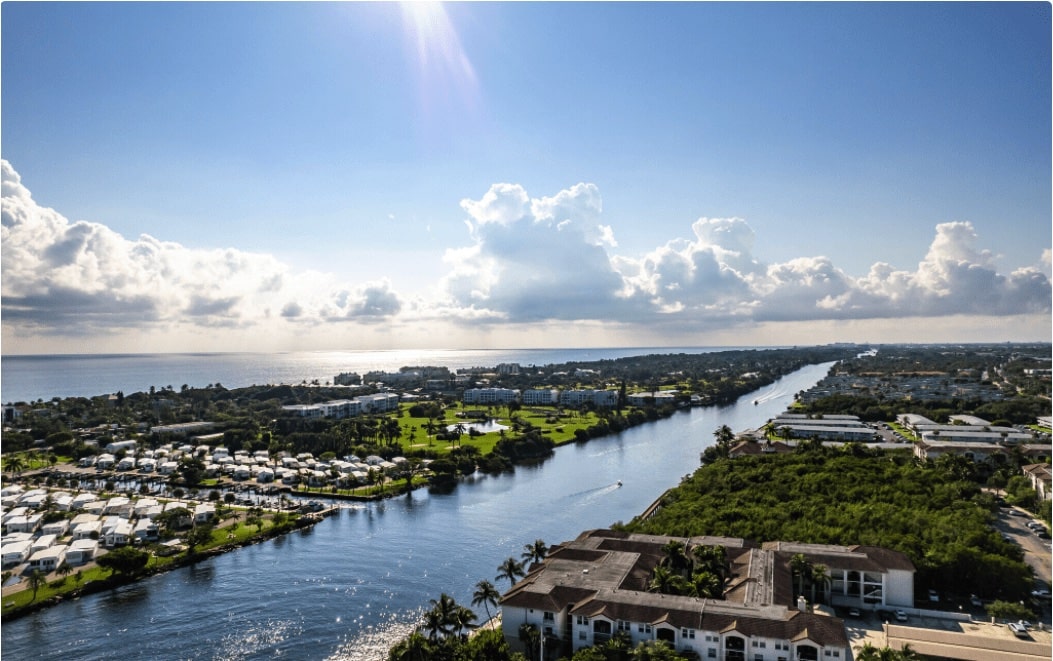 Sunny view of the canal with boats leading out to the ocean near The Villas in Boynton Beach, FL.